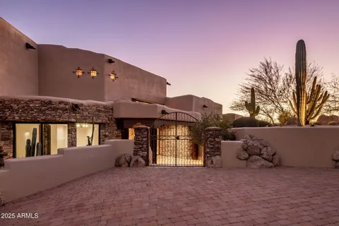 a large kitchen with kitchen island a large counter top stainless steel appliances and cabinets