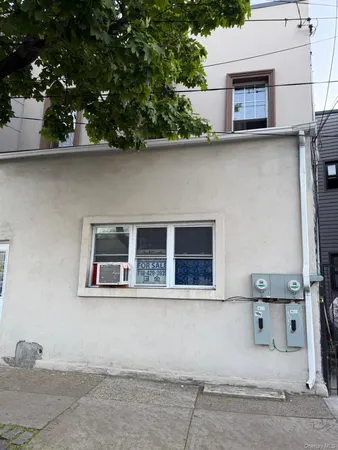 front view of a house with a tree