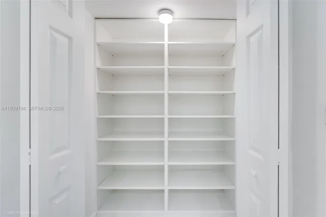a view of walk in closet with empty racks