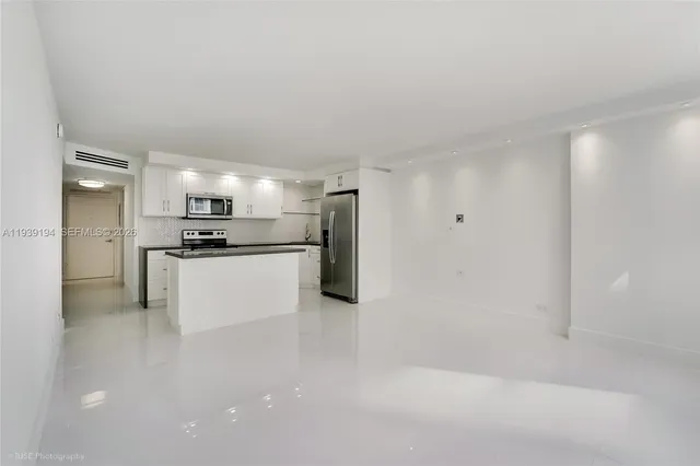 a view of kitchen with refrigerator sink and microwave