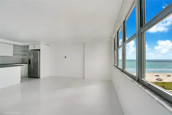 a view of kitchen with refrigerator and window