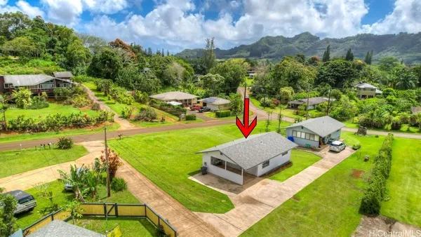 an aerial view of a house with garden space ocean view