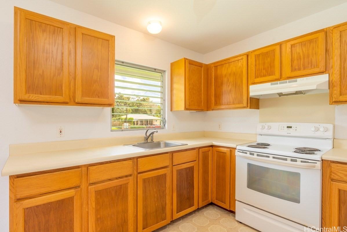 6363 A Puupilo Road Kapaa, HI 96746 - Photo 3 of 19 a kitchen with stainless steel appliances granite countertop white cabinets sink and a microwave