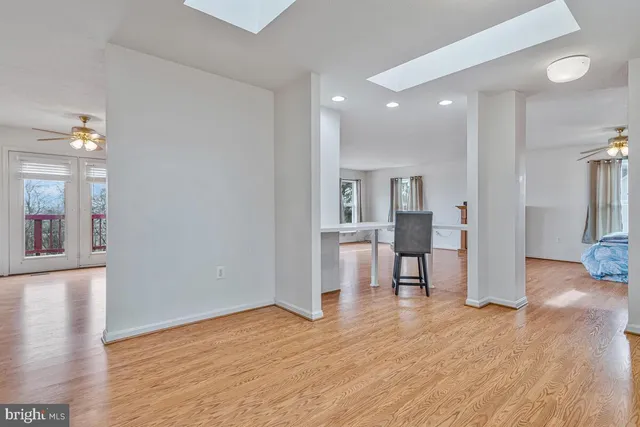 a kitchen with granite countertop a sink cabinets stainless steel appliances and a window