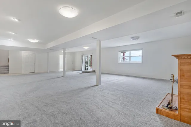 an empty room with a fireplace and a window