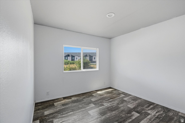 433 North 750 West Logan, UT 84321 - Photo 19 of 40 Spacious room featuring wood-finish flooring, a large window, a recessed ceiling light, and clean white walls