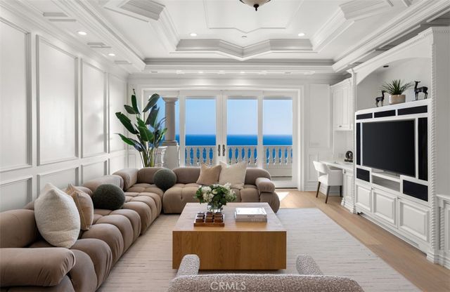 a living room with furniture and large windows