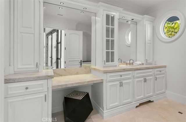 a view of a white house with a swimming pool and wooden fence