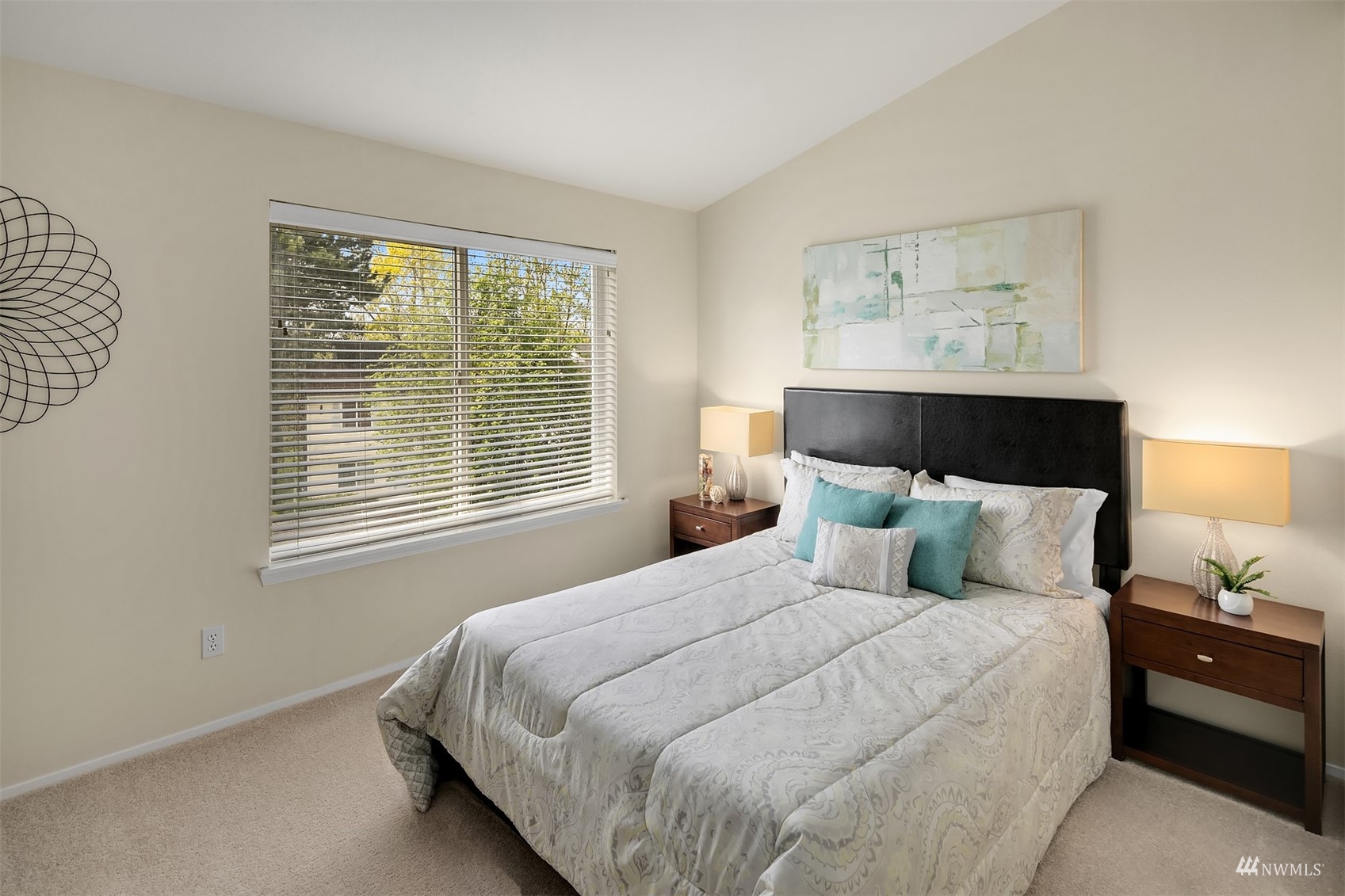 833 Southwest Sunset Boulevard, Unit G37 Renton, WA 98057 - Photo 16 of 21 a bedroom with a bed and a lamp on dresser