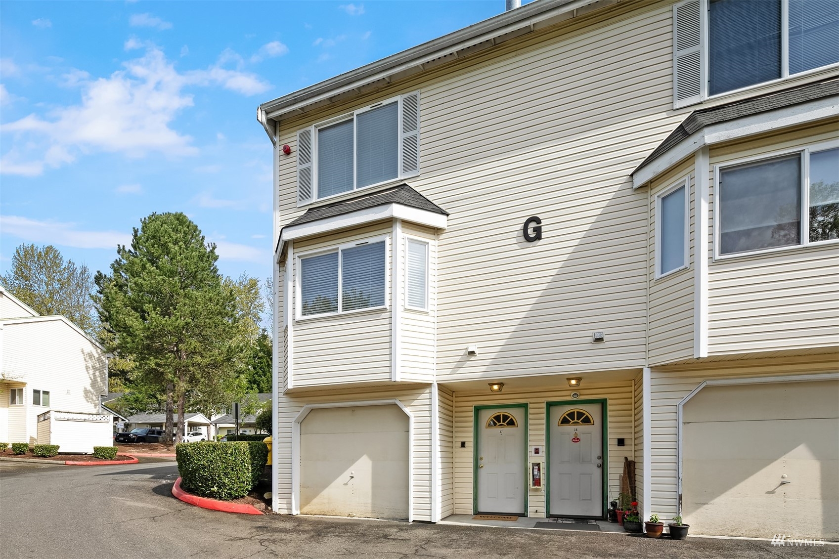 833 Southwest Sunset Boulevard, Unit G37 Renton, WA 98057 - Photo 21 of 21 a front view of a house with garage