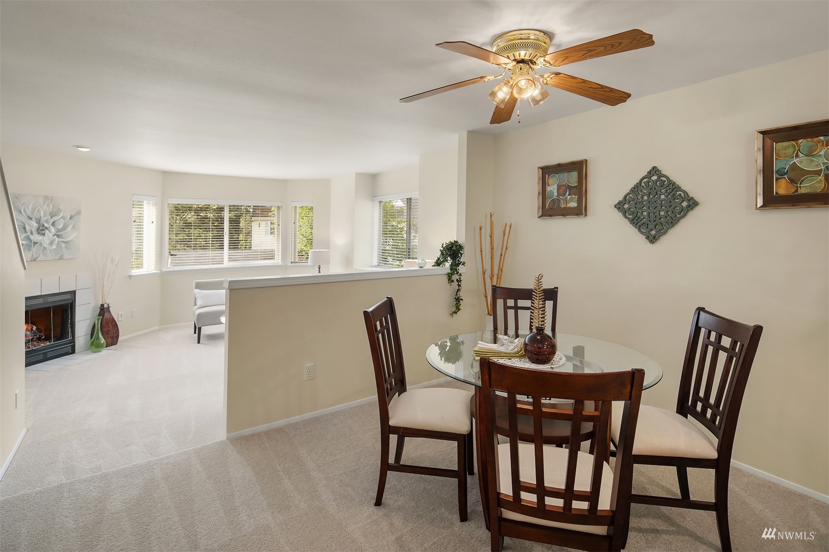 833 Southwest Sunset Boulevard, Unit G37 Renton, WA 98057 - Photo 7 of 21 a view of a dining room with furniture and a chandelier fan
