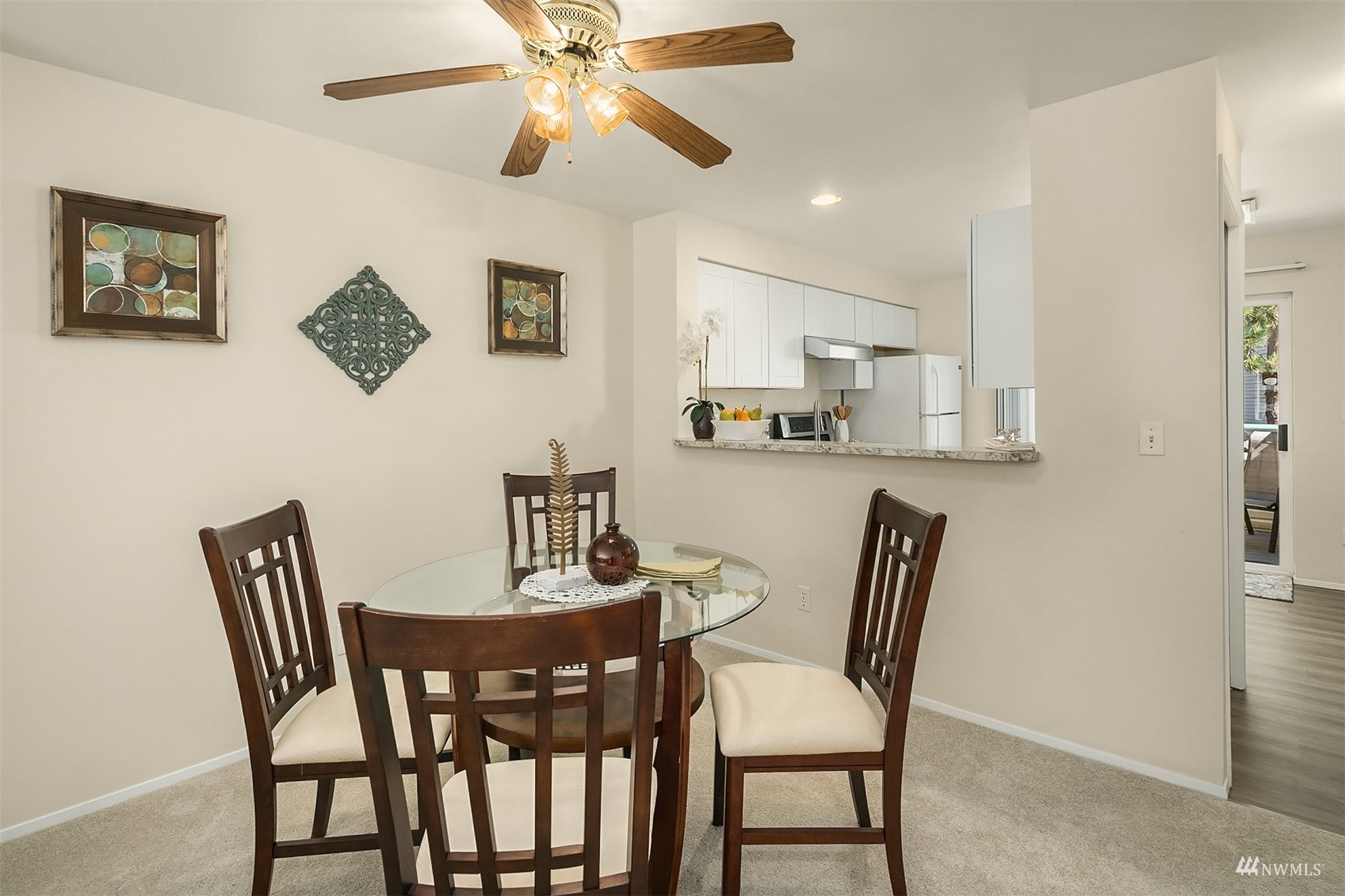833 Southwest Sunset Boulevard, Unit G37 Renton, WA 98057 - Photo 8 of 21 a view of a dining room with furniture and a chandelier fan