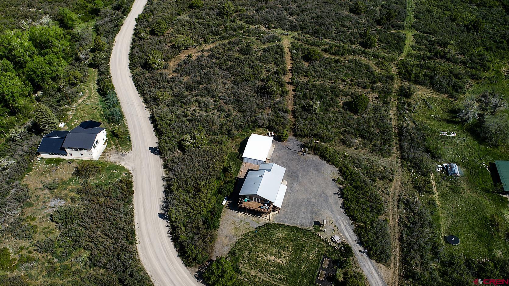 21976 2225th Road Cedaredge, CO 81413 - Photo 3 of 36 an aerial view of a house with a yard and trees