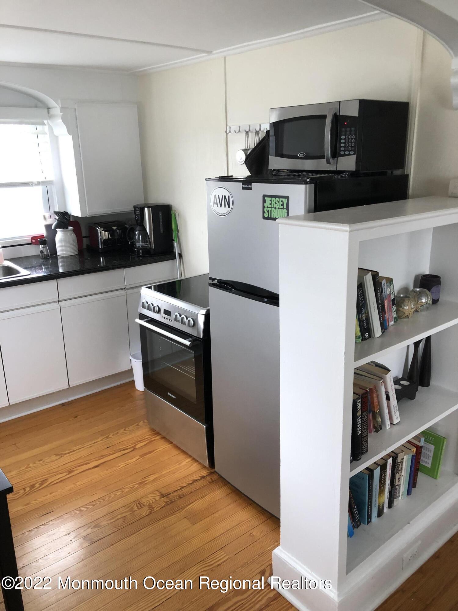 106 Lincoln Lane, Unit WINTER RENTAL Avon-by-the-Sea, NJ 07717 - Photo 6 of 11 a kitchen with stainless steel appliances granite countertop a stove a sink and a refrigerator