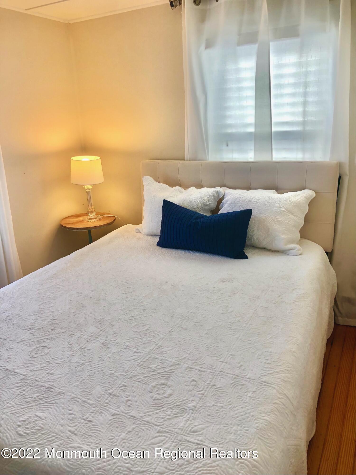 106 Lincoln Lane, Unit WINTER RENTAL Avon-by-the-Sea, NJ 07717 - Photo 9 of 11 a bedroom with a bed and window