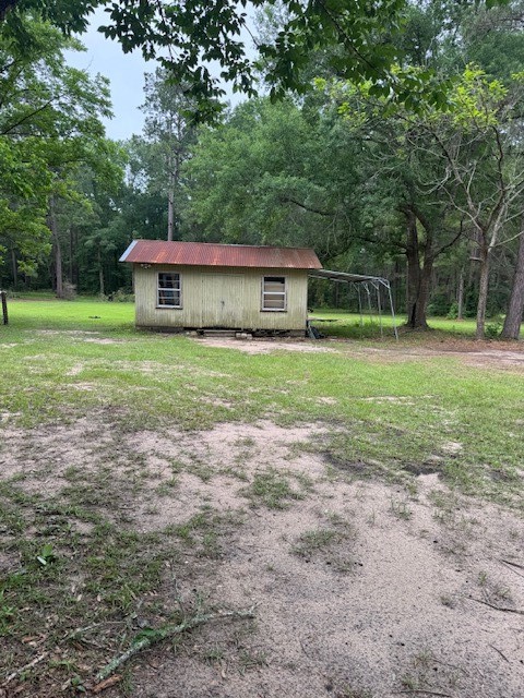9004 Farm To Market 62 Corrigan, TX 75939 - Photo 6 of 27 a view of a big yard with large trees