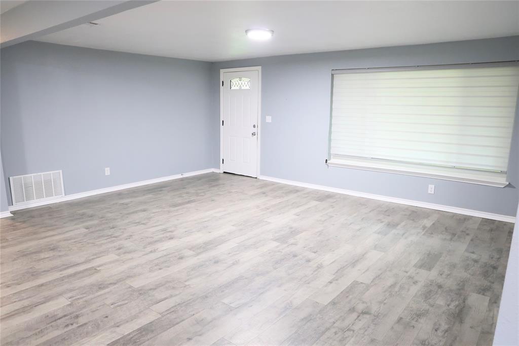 494 Lannius Road Dodd City, TX 75438 - Photo 13 of 40 a view of an empty room with wooden floor and a window