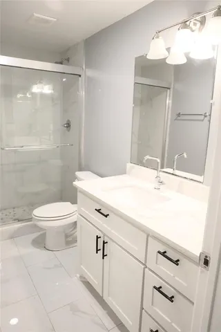 a bathroom with a glass shower door