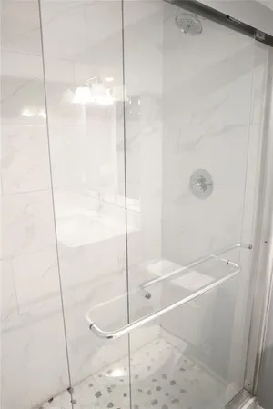 a white toilet sitting next to a bathroom sink and a white cabinet