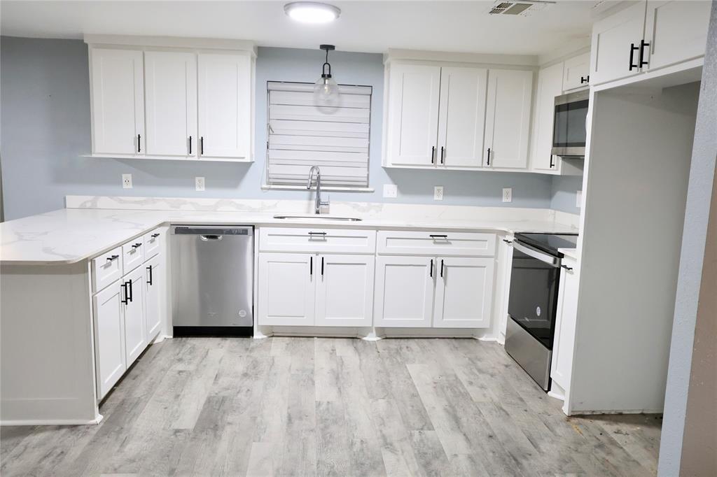494 Lannius Road Dodd City, TX 75438 - Photo 6 of 40 a kitchen with white cabinets stainless steel appliances and sink