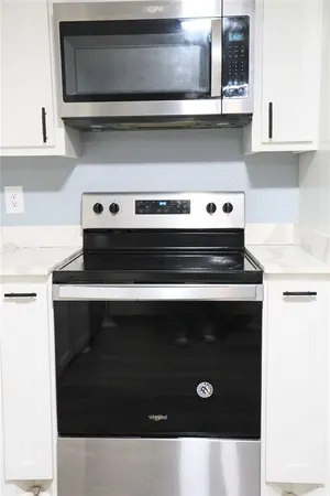 a kitchen with a stove and a microwave