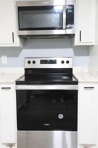 a kitchen with a stove and a microwave