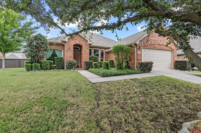 a view of a white house with a yard