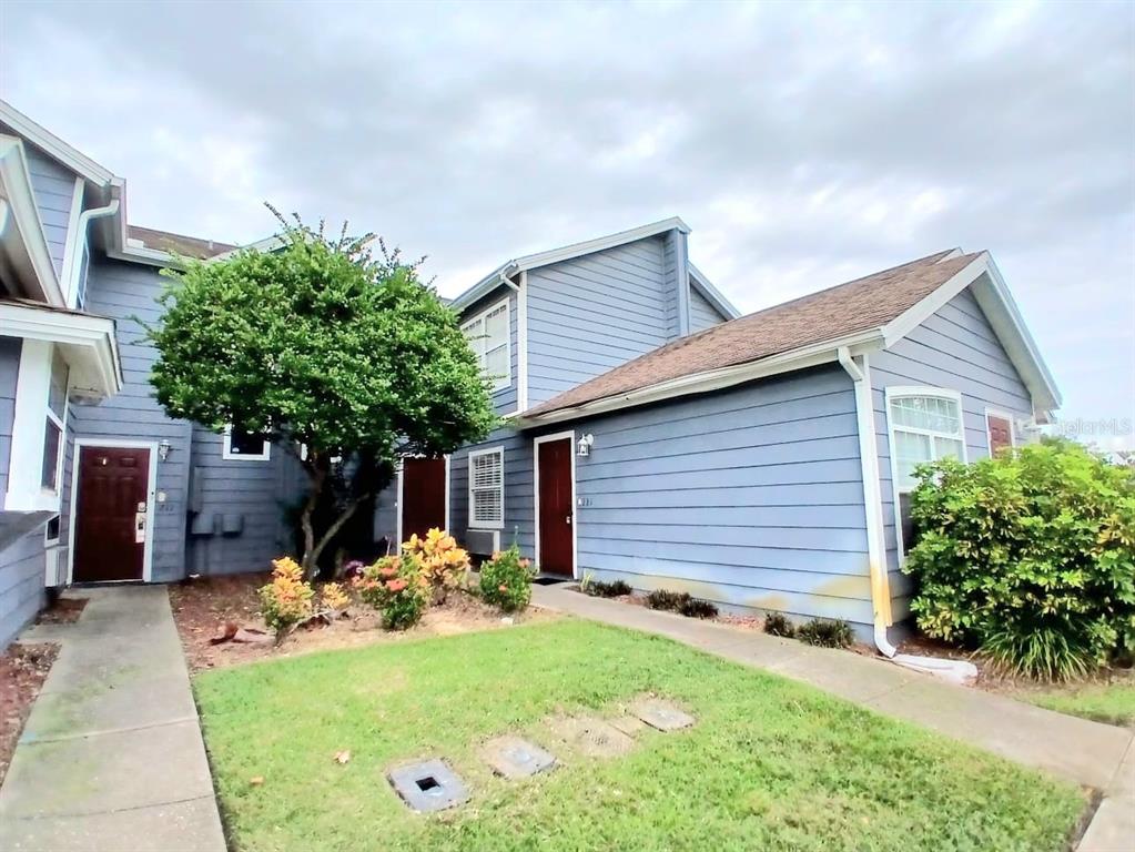 221 Caribbean Drive Davenport, FL 33897 - Photo 1 of 15 a front view of a house with garden