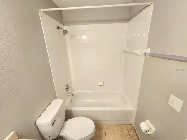 a bathroom with a toilet and a bathtub
