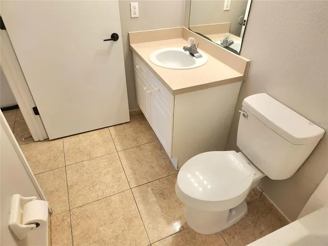 a white toilet sitting next to a bathroom sink