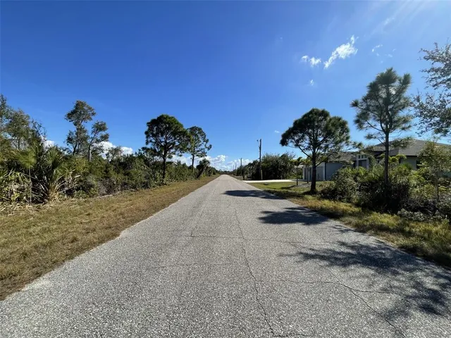 a view of a street with a yard