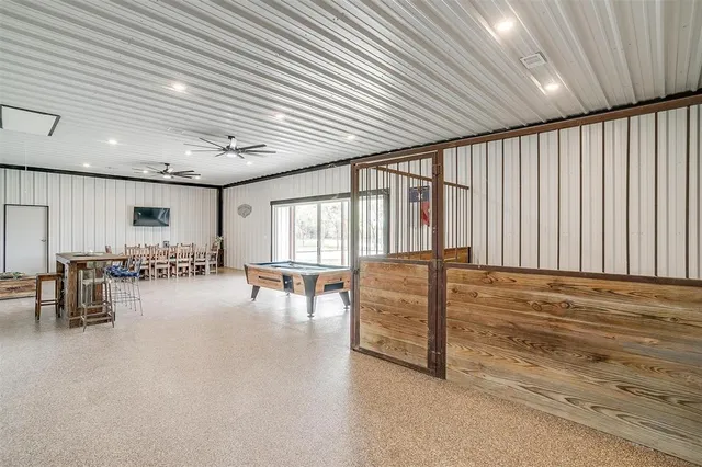 a bathroom with a tub a sink and a large window