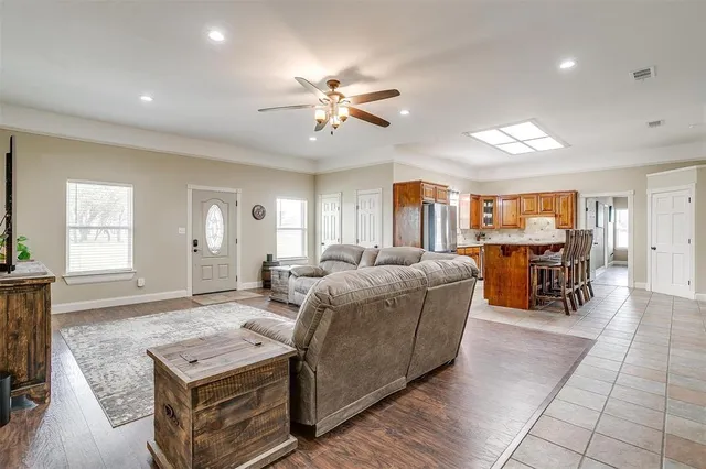 a living room with furniture and a wooden floor