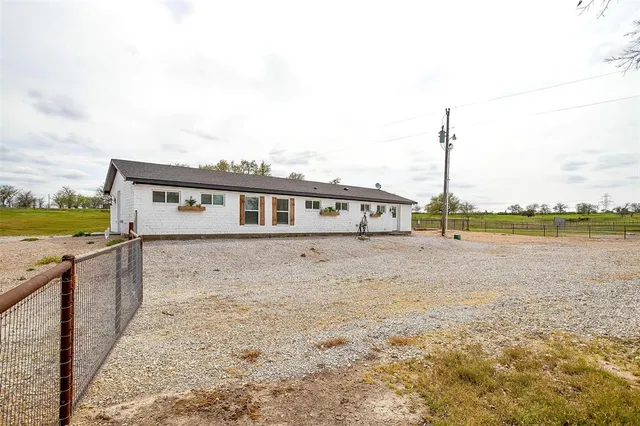 a view of a house with a yard and lake