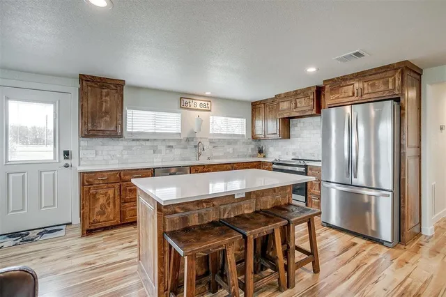 a spacious bedroom with a bed and a flat screen tv