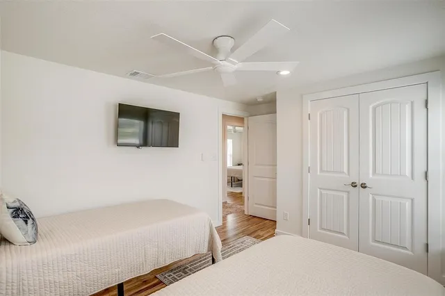 a large white kitchen with a sink and a large window