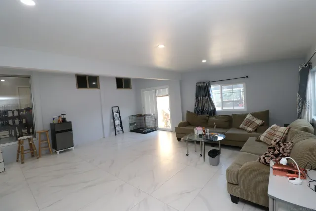 a living room with furniture window and a flat screen tv