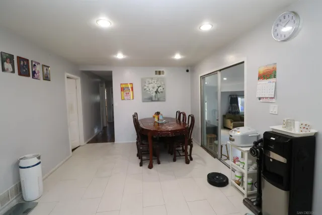 a view of a very nice looking dining room with a table and chairs
