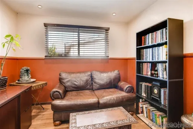 a living room with furniture and a book shelf