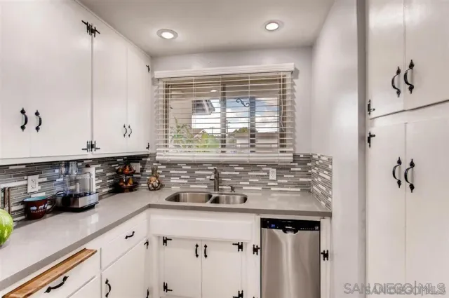 a kitchen with a sink and cabinets