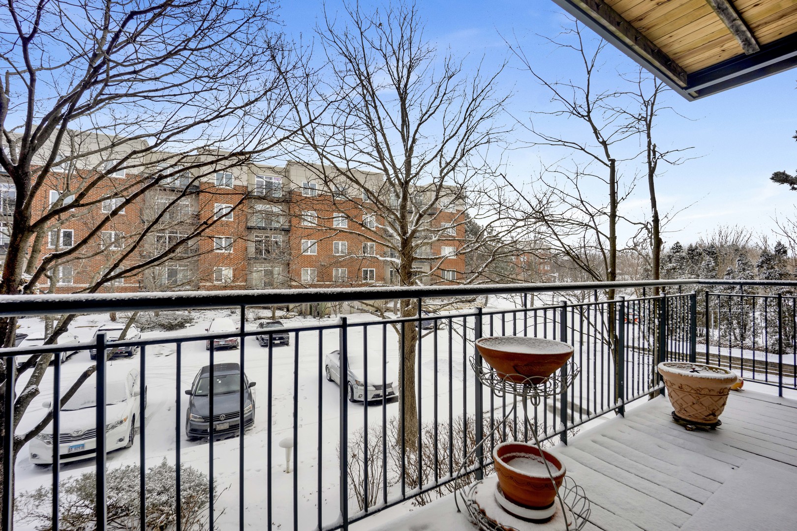 800 Weidner Road, Unit 208 Buffalo Grove, IL 60089 - Photo 17 of 19 a view of a balcony with wooden benches