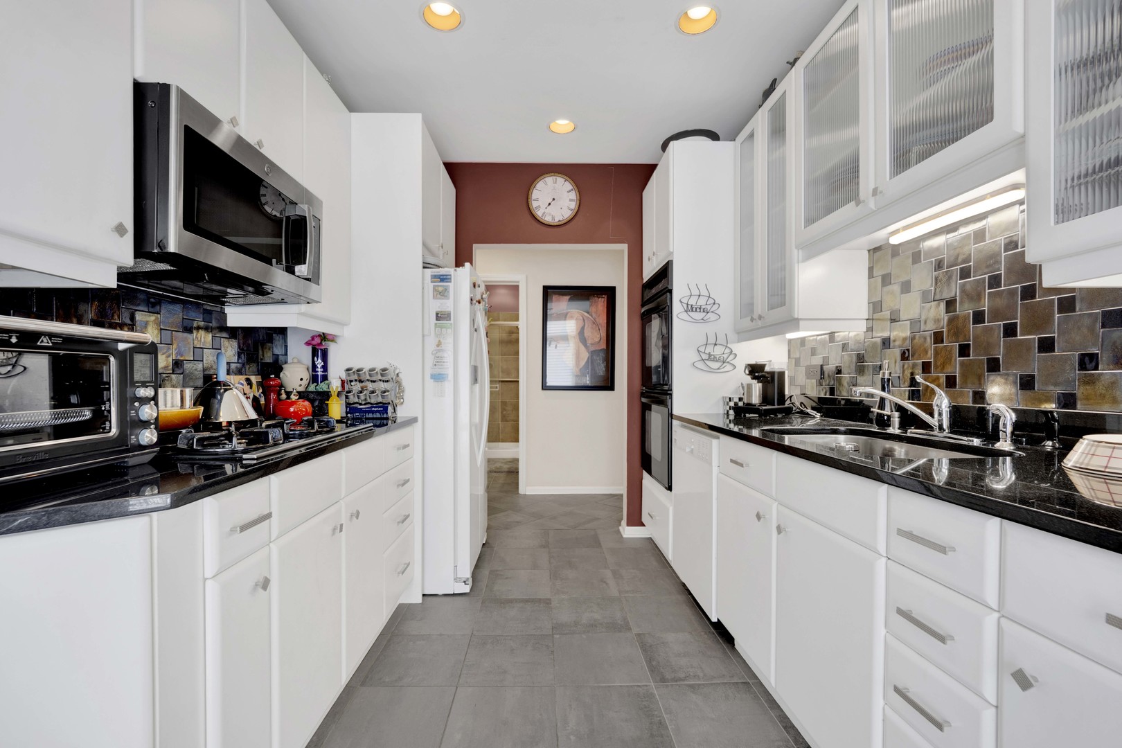 800 Weidner Road, Unit 208 Buffalo Grove, IL 60089 - Photo 5 of 19 a kitchen with stainless steel appliances a sink dishwasher a refrigerator and a microwave