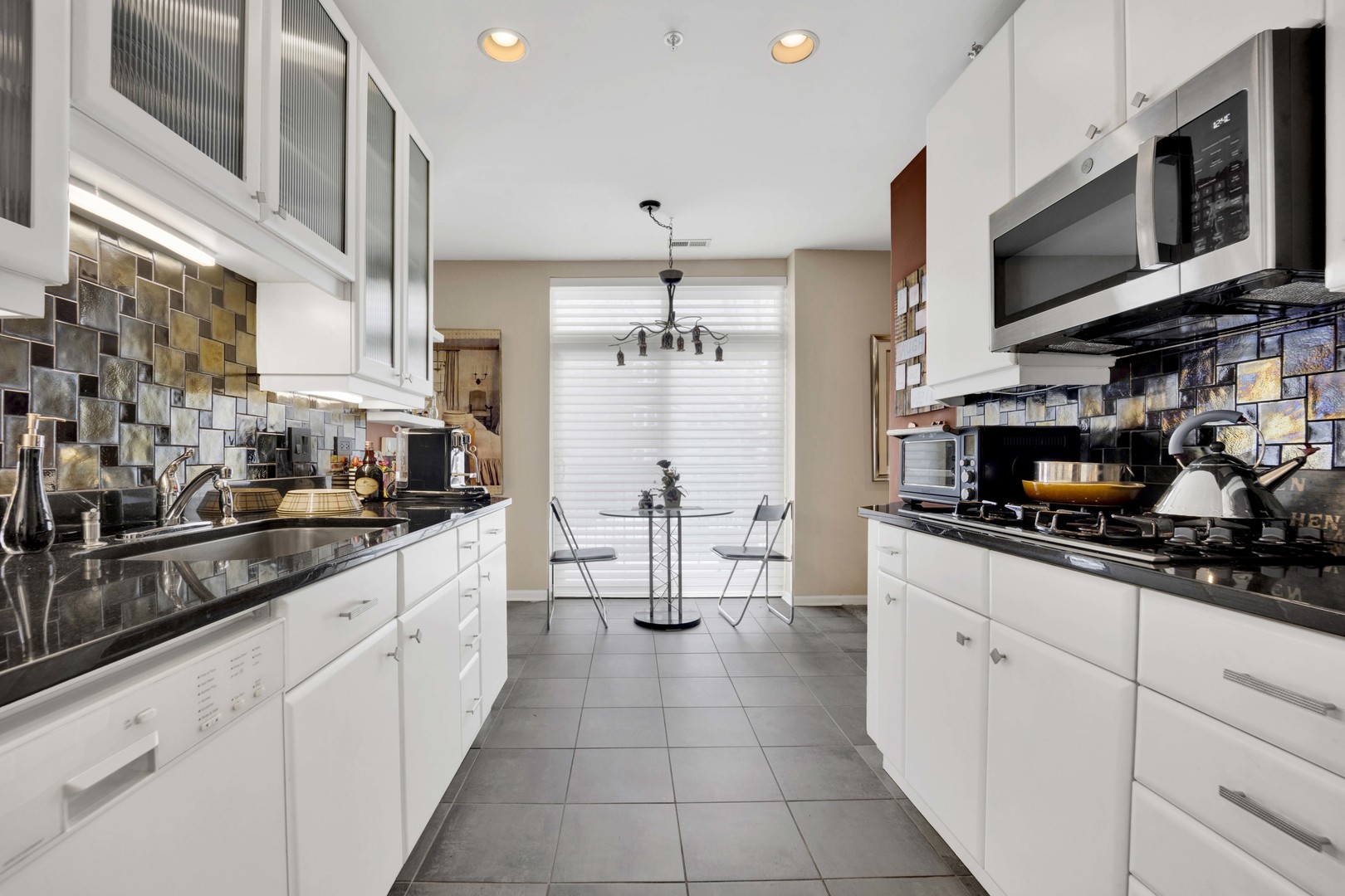 800 Weidner Road, Unit 208 Buffalo Grove, IL 60089 - Photo 6 of 19 a kitchen with stainless steel appliances a sink dishwasher stove microwave and cabinets