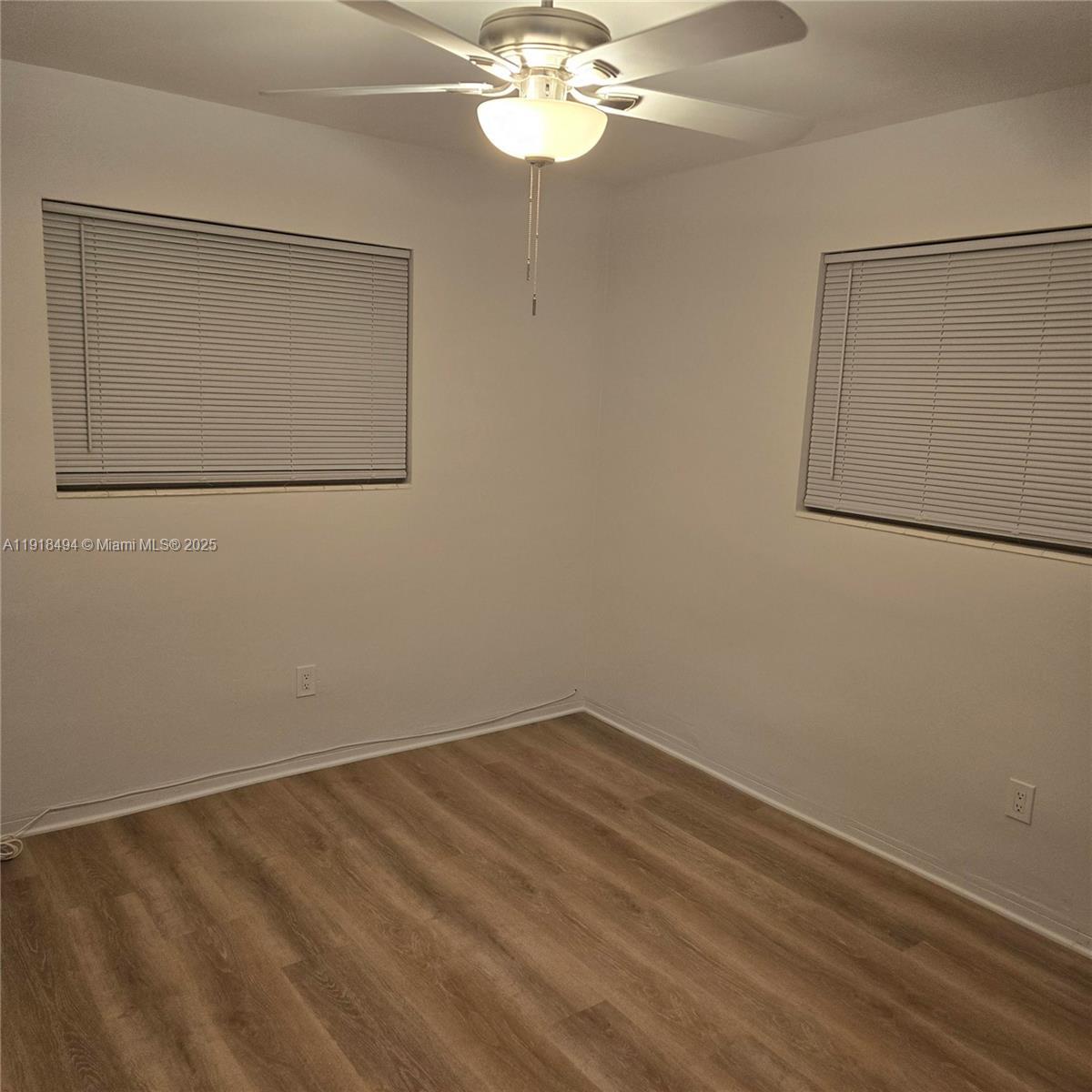 122 Northwest Boulevard, Unit B Miami, FL 33126 - Photo 11 of 17 a view of a small space with wooden floor and a window
