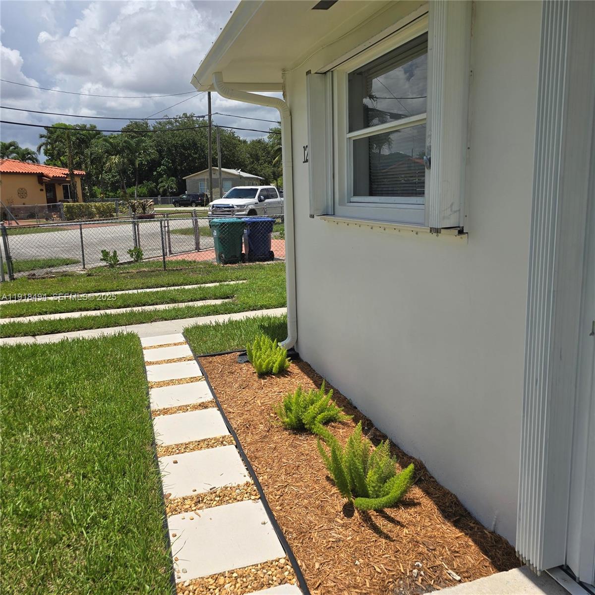 122 Northwest Boulevard, Unit B Miami, FL 33126 - Photo 14 of 17 a view of a two chairs in back yard of the house