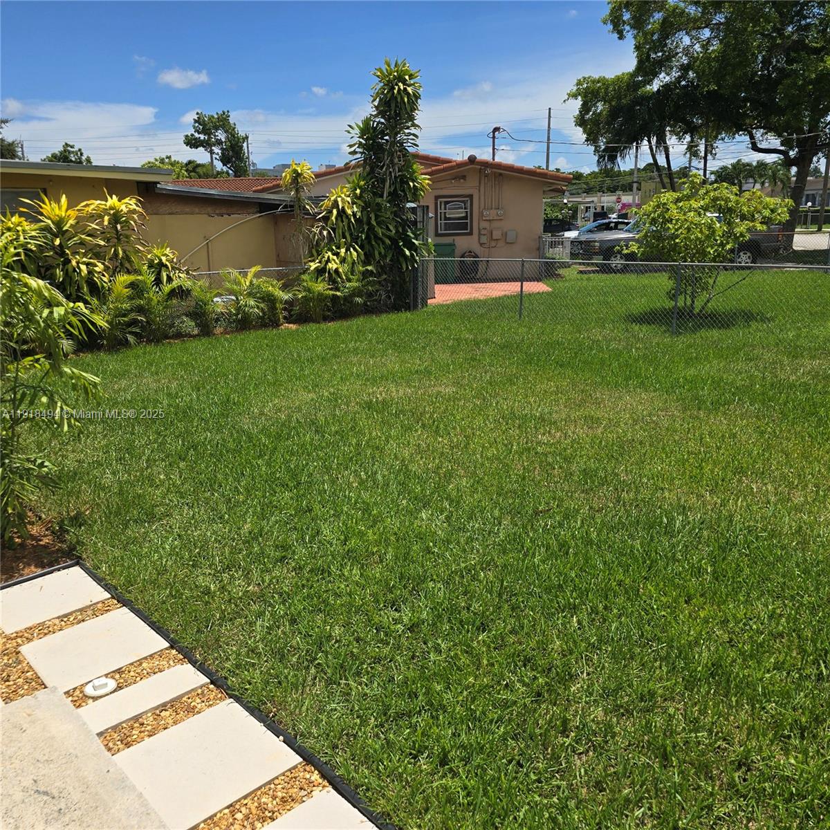122 Northwest Boulevard, Unit B Miami, FL 33126 - Photo 15 of 17 a view of a garden with a house in the background