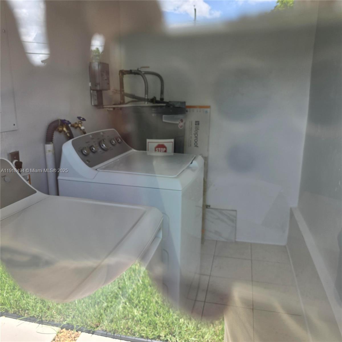 122 Northwest Boulevard, Unit B Miami, FL 33126 - Photo 17 of 17 a utility room with dryer and washer
