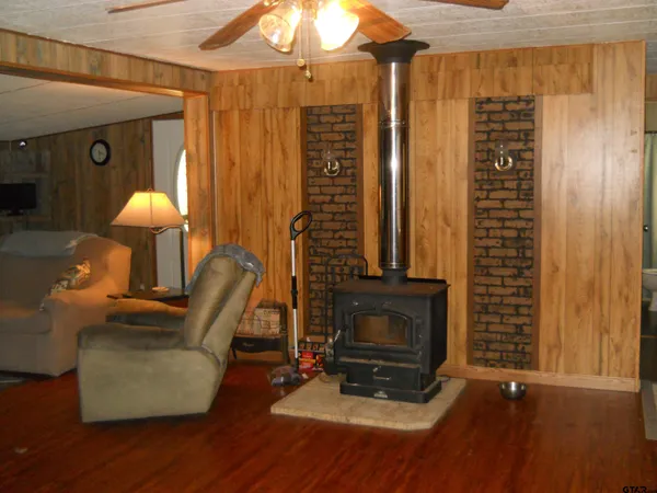 a living room with furniture and a large mirror