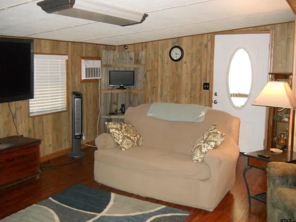 a kitchen with a sink dishwasher a refrigerator and cabinets with wooden floor