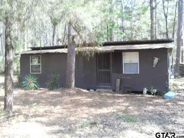 a house view with a sitting space and garden